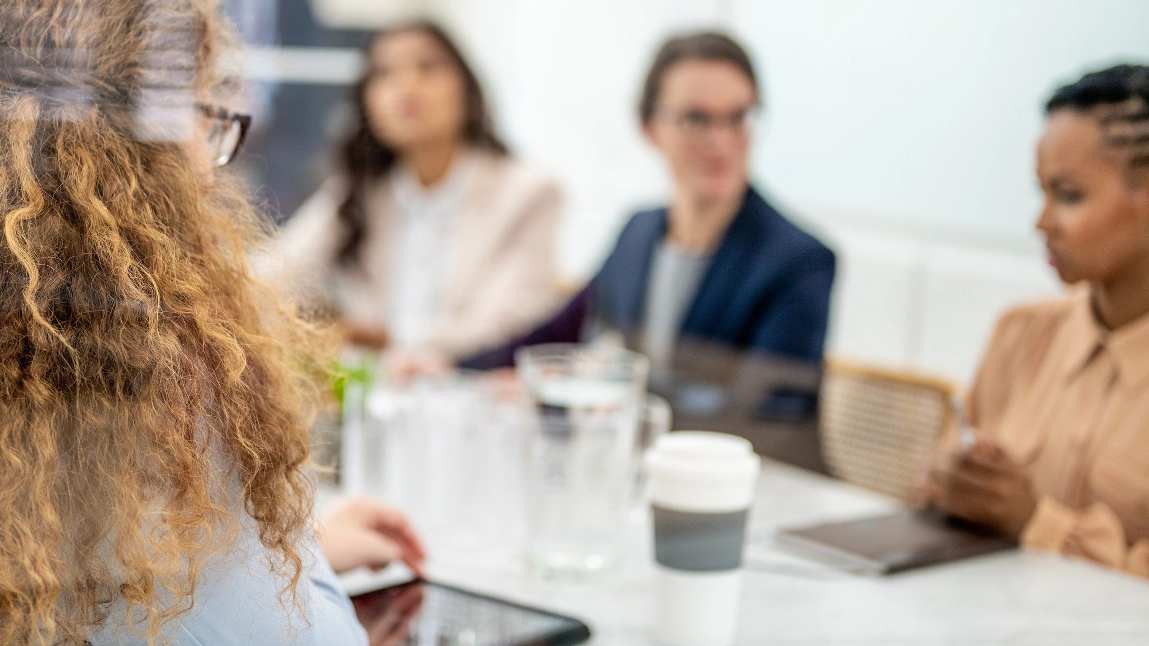 Advisors discussing compliance strategy at a conference table