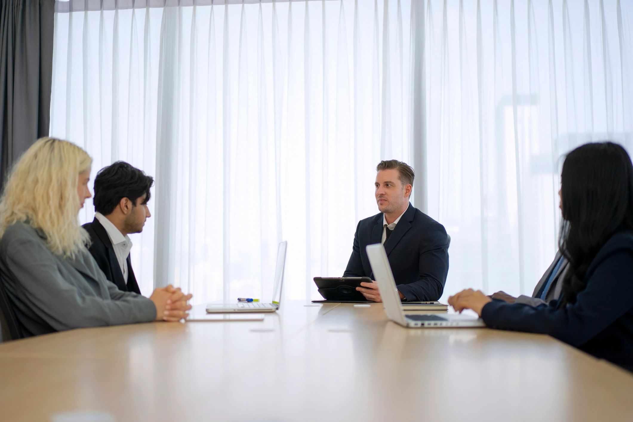 Business professionals reviewing documents in a boardroom